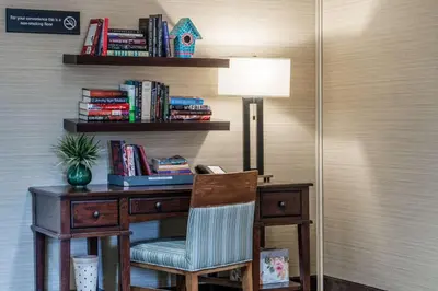 a desk with a chair and a lamp and books at Hampton Inn Downingtown/Exton in Exton