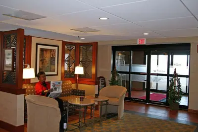 a man sitting on a couch in a hotel room at Hampton Inn Downingtown/Exton in Exton
