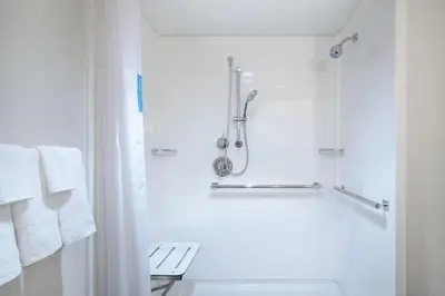 a white bathroom with a shower and a toilet at Hampton Inn Downingtown/Exton in Exton