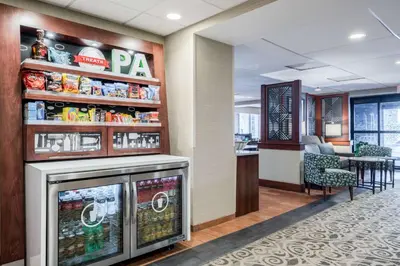 a lobby with a snack bar and a restaurant at Hampton Inn Downingtown/Exton in Exton
