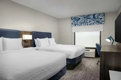 a hotel room with two beds and a window at Hampton Inn Easton in Easton