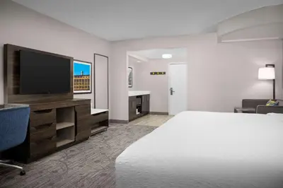 a hotel room with a bed and a flat screen tv at Hampton Inn Easton in Easton