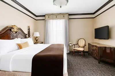 a hotel room with a large bed and a television at Hotel Lucerne in New York
