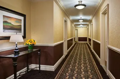 a hallway of a hotel with a table and flowers at Hotel Lucerne in New York