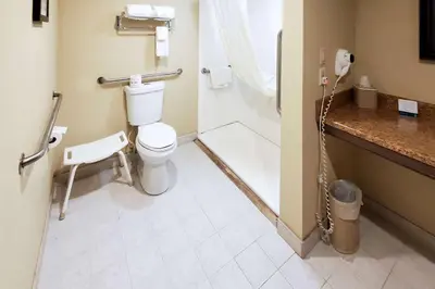 a bathroom with a toilet and a sink at Quality Inn & Suites Quakertown-Allentown in Quakertown