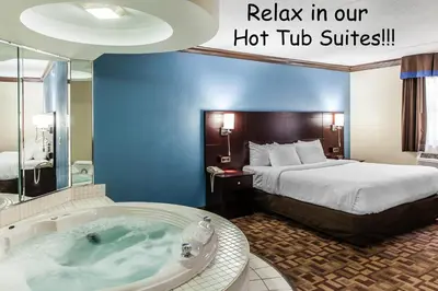 a hotel room with a hot tub and a bed at Quality Inn & Suites Quakertown-Allentown in Quakertown