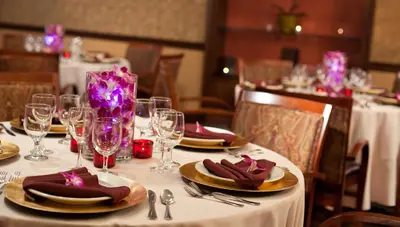 a table with a white table cloth with plates and glasses at Chestnut Hill Hotel in Philadelphia