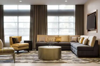 a living room with a couch and a table at Hilton Garden Inn Newtown Square Radnor in Newtown Square