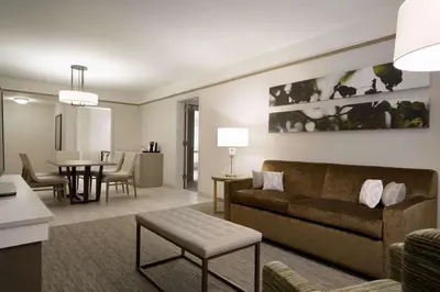 a living room with a couch and a dining room at Hilton Garden Inn Newtown Square Radnor in Newtown Square