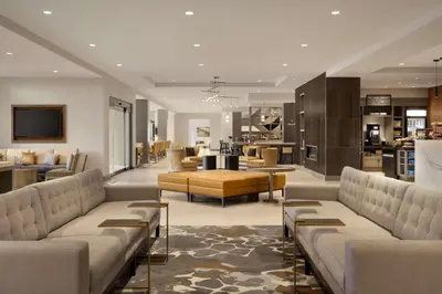 a large living room with couches and a kitchen at Hilton Garden Inn Newtown Square Radnor in Newtown Square