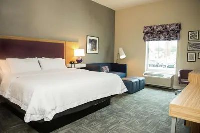 a hotel room with a large bed and a window at Hampton Inn & Suites Warrington Horsham in Warrington