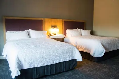 a hotel room with two beds with white sheets at Hampton Inn & Suites Warrington Horsham in Warrington