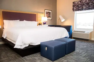 a hotel room with a large bed and a window at Hampton Inn & Suites Warrington Horsham in Warrington