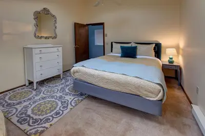 a bedroom with a bed and a dresser and a mirror at The Guest House in Margaretville