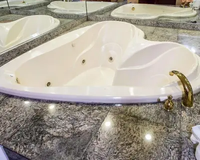 a bath tub on a marble counter with a faucet at Rodeway Inn Jersey City North in Jersey City