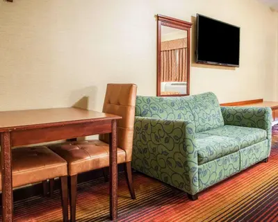 a living room with a couch and a table at Rodeway Inn Jersey City North in Jersey City