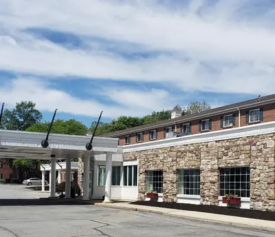 a brick building with a parking lot in front of it at Heritage Hotel Lancaster in Lancaster
