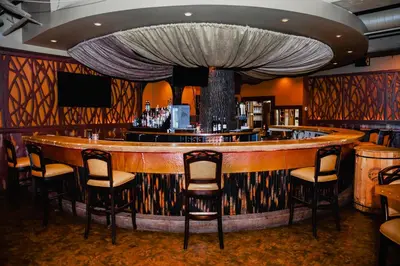 a bar in a restaurant with chairs around it at Heritage Hotel Lancaster in Lancaster