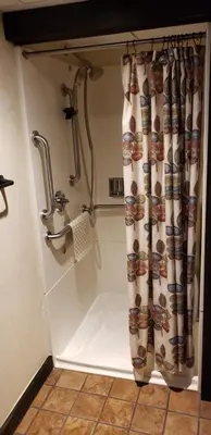 a shower stall with a shower curtain in a bathroom at Heritage Hotel Lancaster in Lancaster