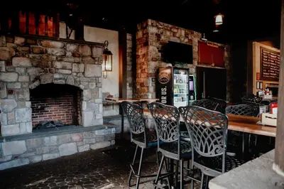 a bar with chairs and a fireplace in a restaurant at Heritage Hotel Lancaster in Lancaster