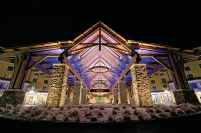 a building with a lit up facade at night at Mount Airy Casino Resort - Adults Only 21 Plus in Mount Pocono