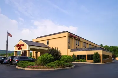 a hotel with cars parked in a parking lot at Hampton Inn Danville in Danville