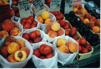 a bunch of baskets of peaches and other fruit on display at Hampton Inn Danville in Danville