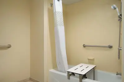 a bathroom with a shower and a toilet with a stool at Hampton Inn Lehighton - Jim Thorpe in Lehighton