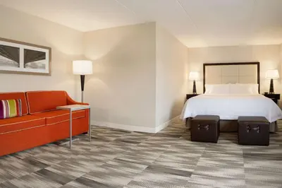 a hotel room with a bed and a couch at Hampton Inn Lehighton - Jim Thorpe in Lehighton