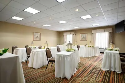 a room with tables and chairs with white table cloths at Hampton Inn Lehighton - Jim Thorpe in Lehighton