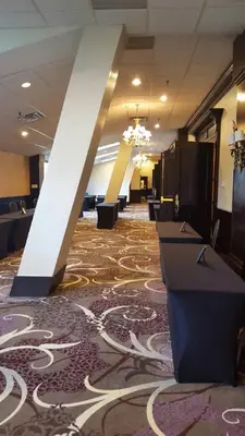 a lobby with a large rug on the floor at APA Hotel Woodbridge in Iselin
