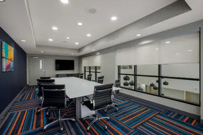 an office with a conference room with a table and chairs at Hampton Inn Linden in Linden