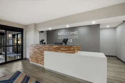 a lobby with a welcome to the academy sign on a wall at Hampton Inn Linden in Linden