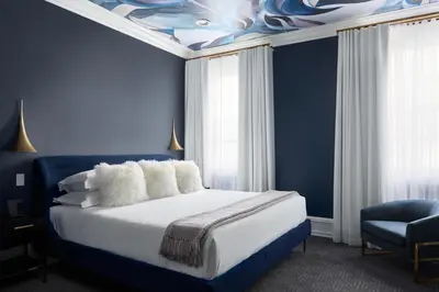 a blue bedroom with a bed with a blue ceiling at The Franklin on Rittenhouse, A Boutique Hotel in Philadelphia