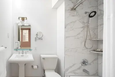 a bathroom with a toilet and a sink and a shower at The Franklin on Rittenhouse, A Boutique Hotel in Philadelphia