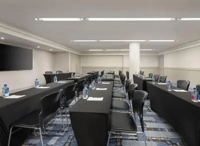 a conference room with black tables and chairs at Hilton New York Fashion District in New York