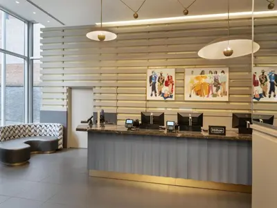 a waiting room with a counter and chairs at Hilton New York Fashion District in New York