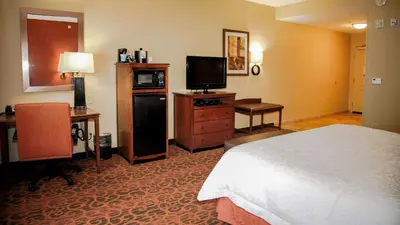 a hotel room with a bed and a flat screen tv at Hampton Inn Matamoras in Matamoras