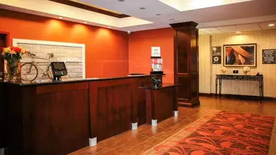 a lobby with a reception desk and a bike on the wall at Hampton Inn Matamoras in Matamoras