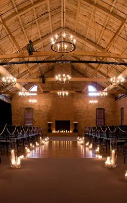 a banquet hall with a table and chairs and lights at Cork Factory Hotel in Lancaster