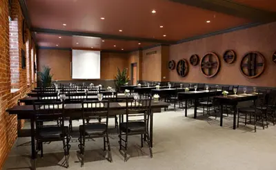 a dining room with tables and chairs in a room at Cork Factory Hotel in Lancaster