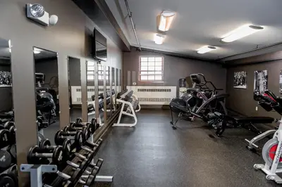 a gym with several treadmills and exercise bikes at Cork Factory Hotel in Lancaster