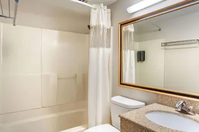 a bathroom with a toilet and a sink and a shower at Days Inn by Wyndham Wrightstown McGuire AFB Bordentown in Wrightstown