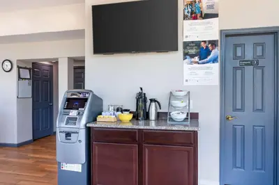 a kitchen with a counter and a tv on the wall at Days Inn by Wyndham Wrightstown McGuire AFB Bordentown in Wrightstown
