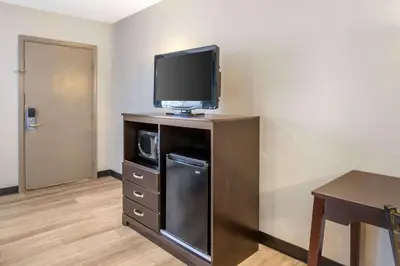 a room with a tv on top of a dresser at Days Inn by Wyndham Wrightstown McGuire AFB Bordentown in Wrightstown