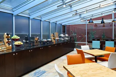 a restaurant with a counter with tables and chairs at Fairfield Inn & Suites by Marriott New York Manhattan/Chelsea in New York