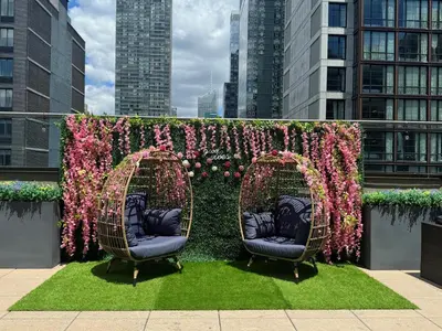 two wicker chairs in front of a wall of flowers at Fairfield Inn & Suites by Marriott New York Manhattan/Chelsea in New York