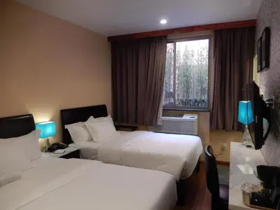 a hotel room with two beds and a window at Quality Inn near Sunset Park in Brooklyn