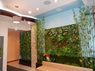 an office lobby with a green wall with plants at Quality Inn near Sunset Park in Brooklyn
