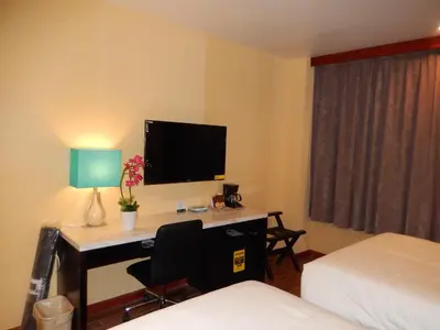 a room with a desk with a computer and a tv at Quality Inn near Sunset Park in Brooklyn